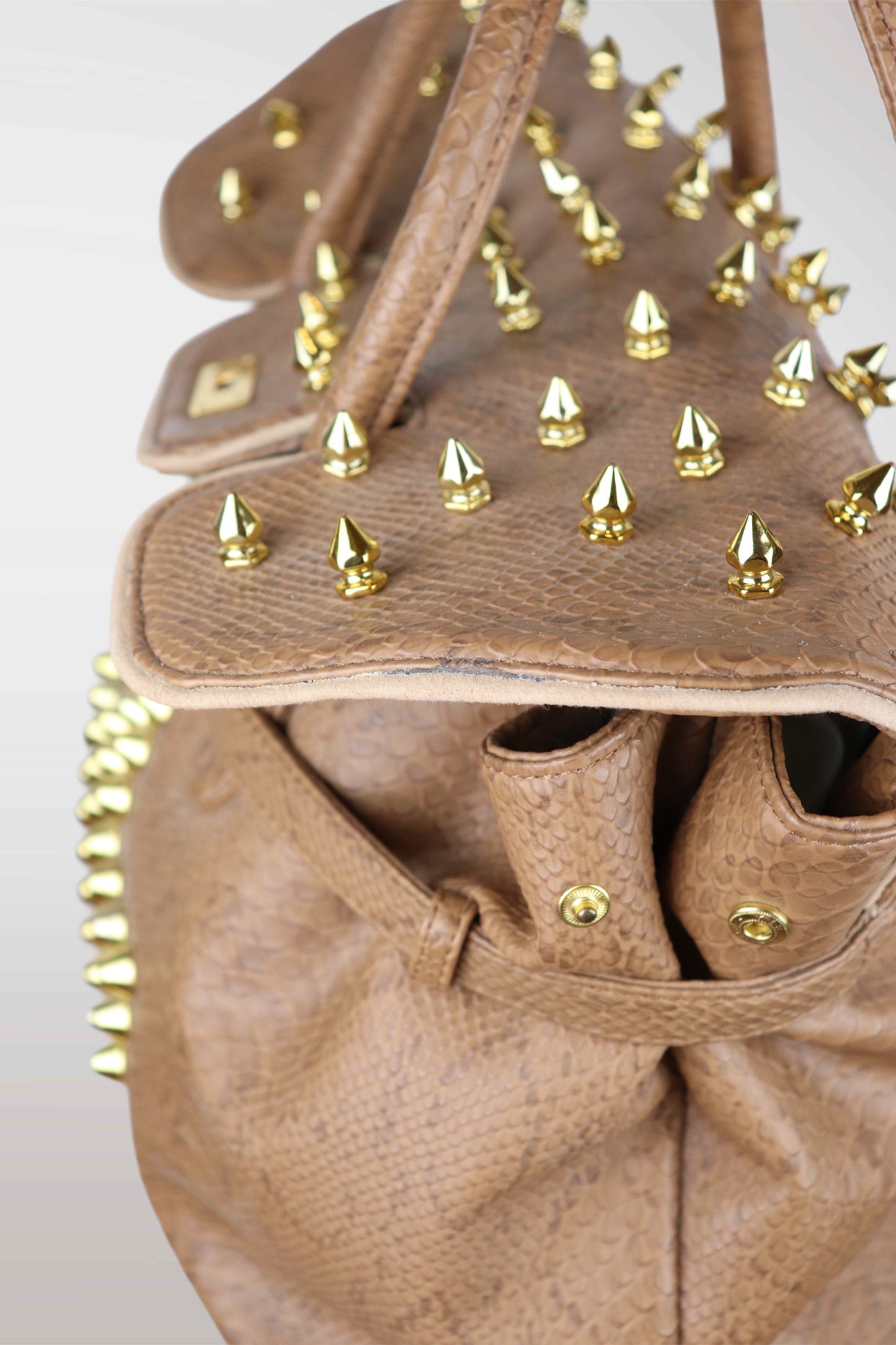 Brown leather handbag with gold spikes on a white background
mint condition vintage
designer archive piece
rare runway sample
one of a kind vintage
limited edition designer
authentic vintage designer
rare vintage designer find
collectible vintage fashion
high-end vintage clothing
luxury vintage apparel
designer vintage statement piece
genuine vintage couture
archival designer clothing
runway vintage fashion
vintage designer investment piece