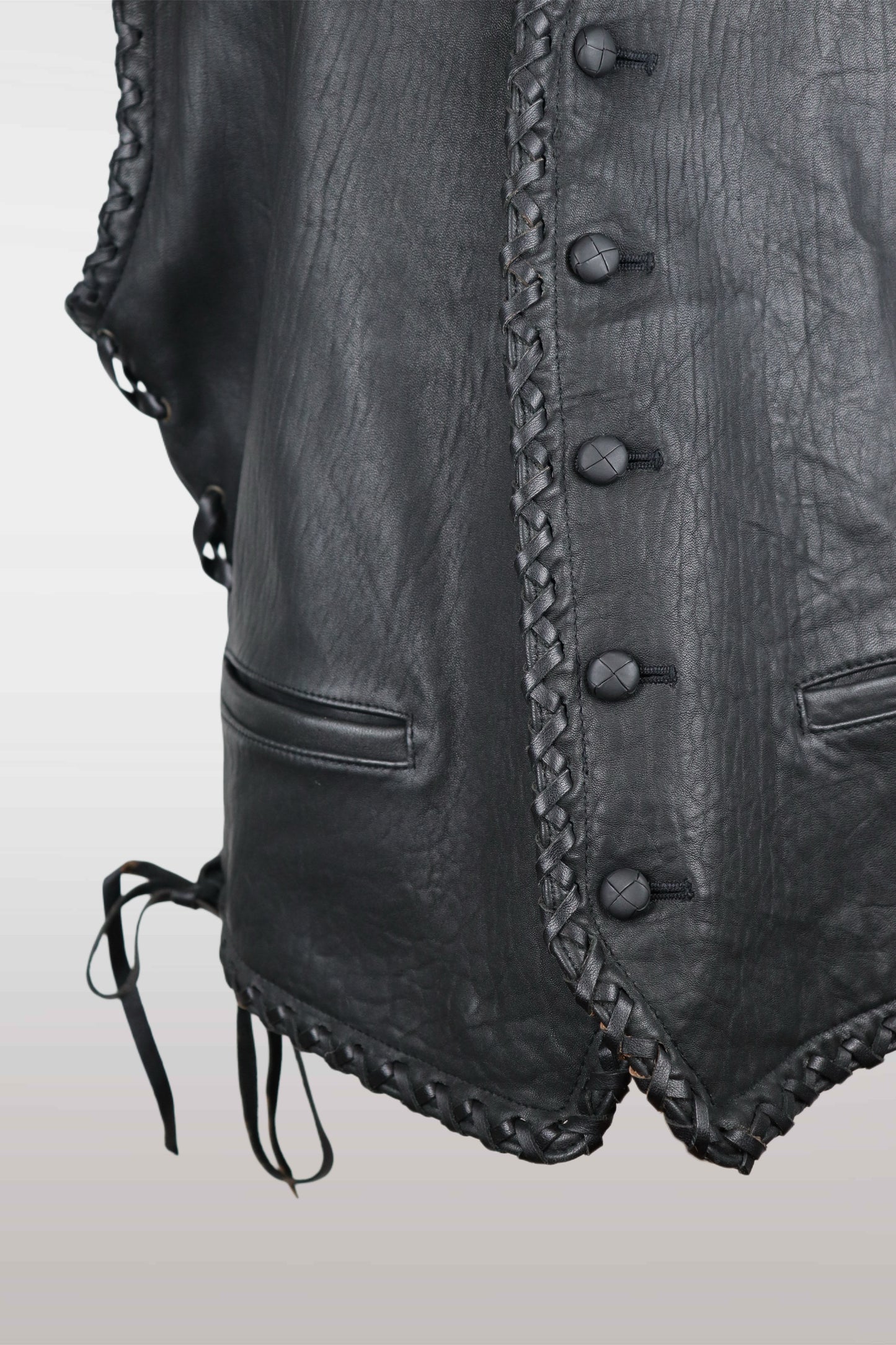 Close-up of a black leather vest with buttons and braided details on a light gray background
mint condition vintage
designer archive piece
rare runway sample
one of a kind vintage
limited edition designer
authentic vintage designer
rare vintage designer find
collectible vintage fashion
high-end vintage clothing
luxury vintage apparel
designer vintage statement piece
genuine vintage couture
archival designer clothing
runway vintage fashion
vintage designer investment piece