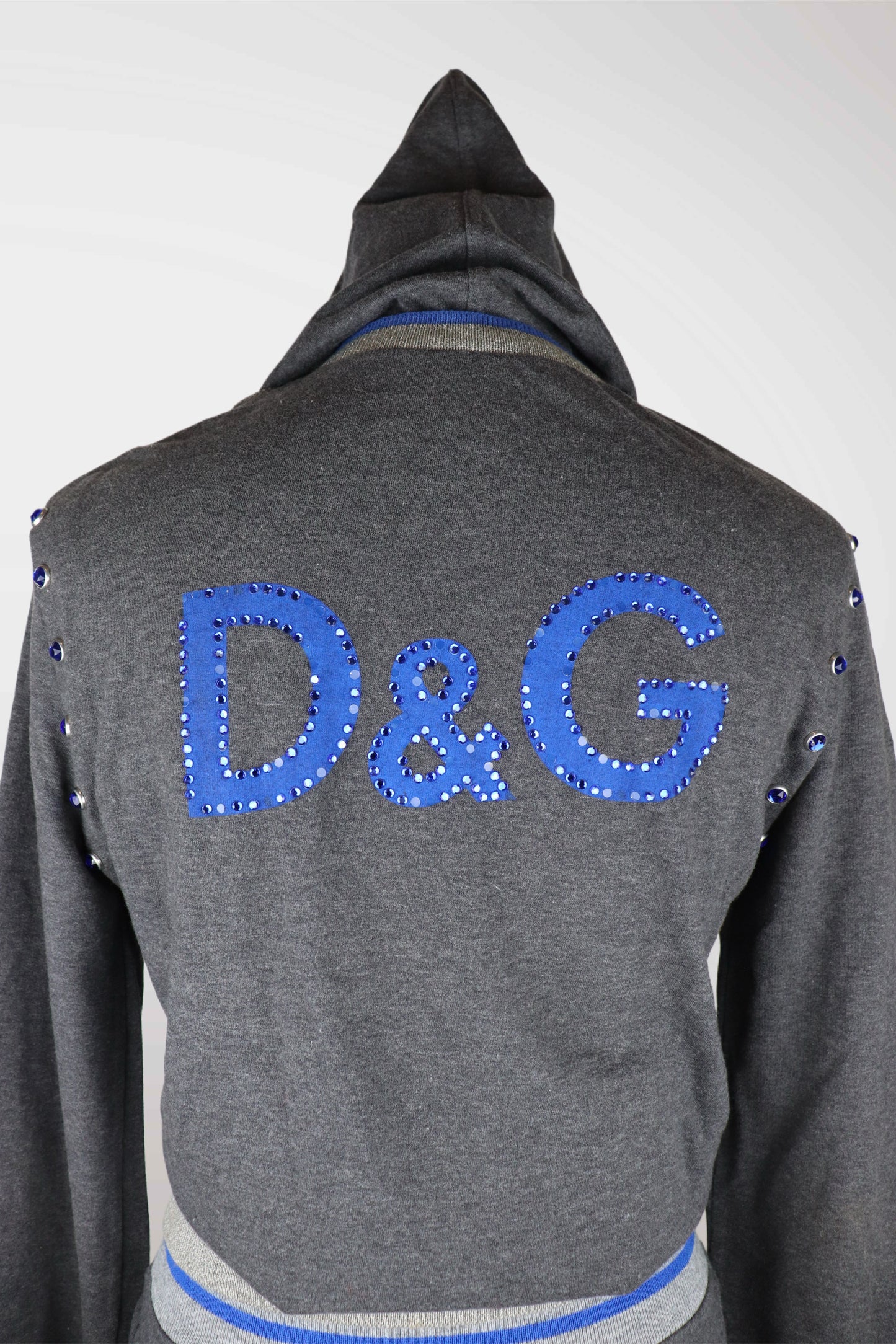Gray hoodie with blue 'D&G' logo on the back against a white background
mint condition vintage
designer archive piece
rare runway sample
one of a kind vintage
limited edition designer
authentic vintage designer
rare vintage designer find
collectible vintage fashion
high-end vintage clothing
luxury vintage apparel
designer vintage statement piece
genuine vintage couture
archival designer clothing
runway vintage fashion
vintage designer investment piece