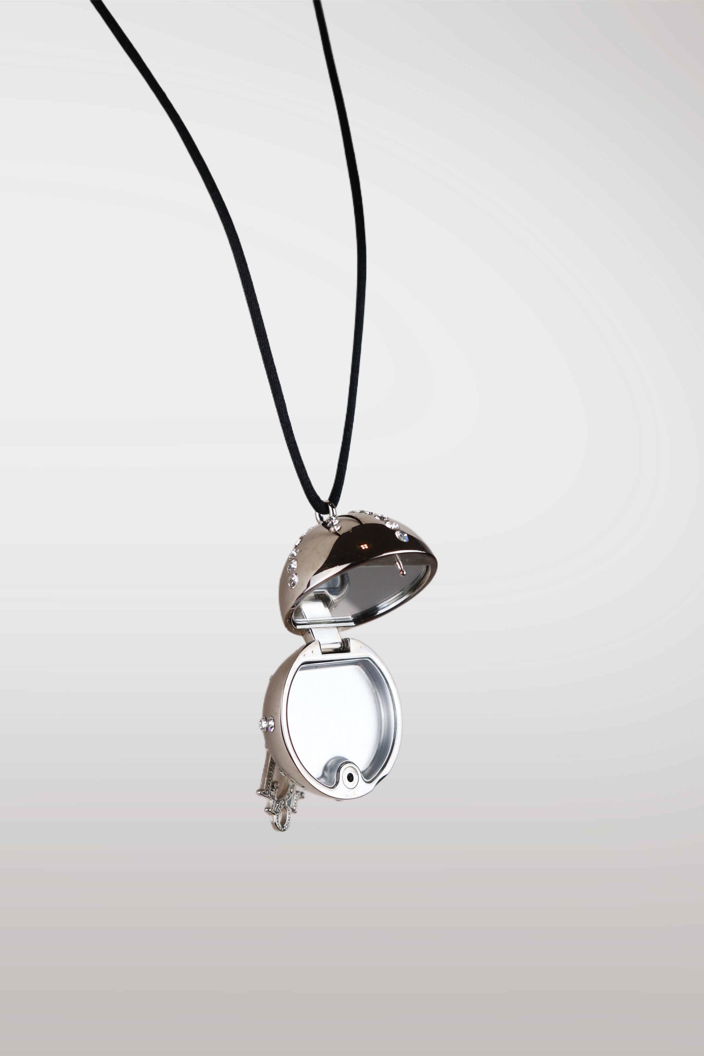 christian dior silver locket with a black cord on a white background
mint condition vintage
designer archive piece
rare runway sample
one of a kind vintage
limited edition designer
authentic vintage designer
rare vintage designer find
collectible vintage fashion
high-end vintage clothing
luxury vintage apparel
designer vintage statement piece
genuine vintage couture
archival designer clothing
runway vintage fashion
vintage designer investment piece