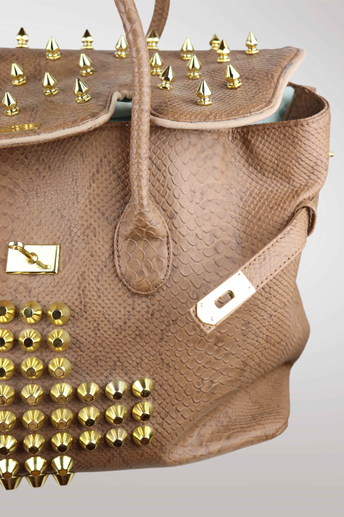 Brown handbag with gold studs on a light gray background
mint condition vintage
designer archive piece
rare runway sample
one of a kind vintage
limited edition designer
authentic vintage designer
rare vintage designer find
collectible vintage fashion
high-end vintage clothing
luxury vintage apparel
designer vintage statement piece
genuine vintage couture
archival designer clothing
runway vintage fashion
vintage designer investment piece