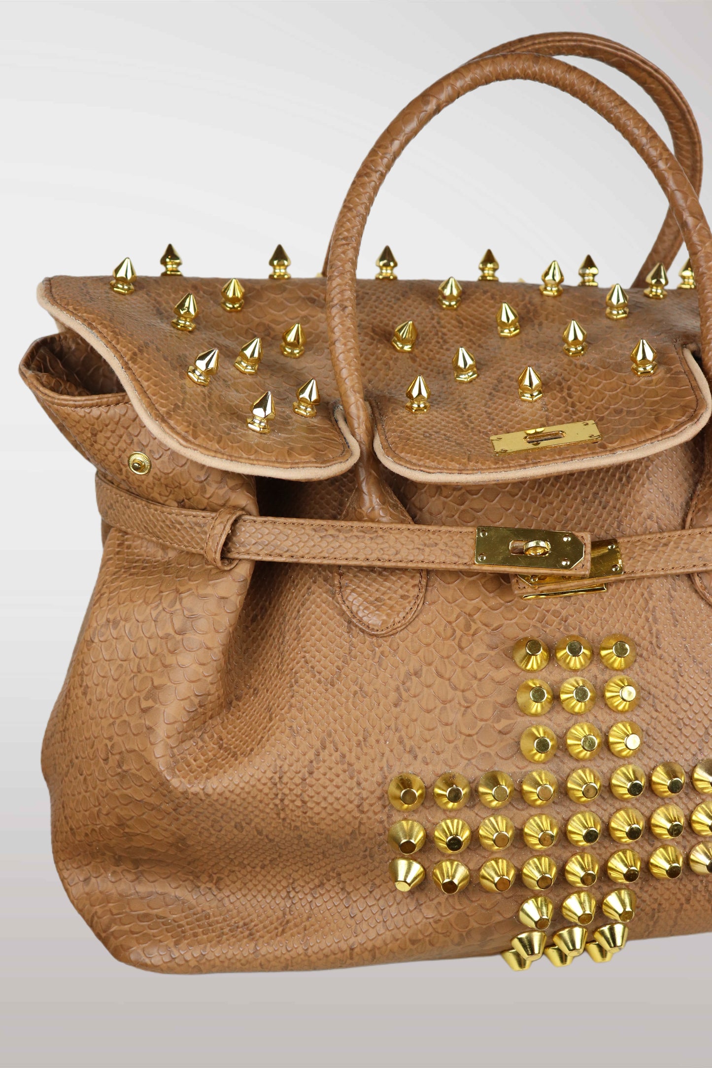 Brown handbag with gold studs on a light gray background
mint condition vintage
designer archive piece
rare runway sample
one of a kind vintage
limited edition designer
authentic vintage designer
rare vintage designer find
collectible vintage fashion
high-end vintage clothing
luxury vintage apparel
designer vintage statement piece
genuine vintage couture
archival designer clothing
runway vintage fashion
vintage designer investment piece