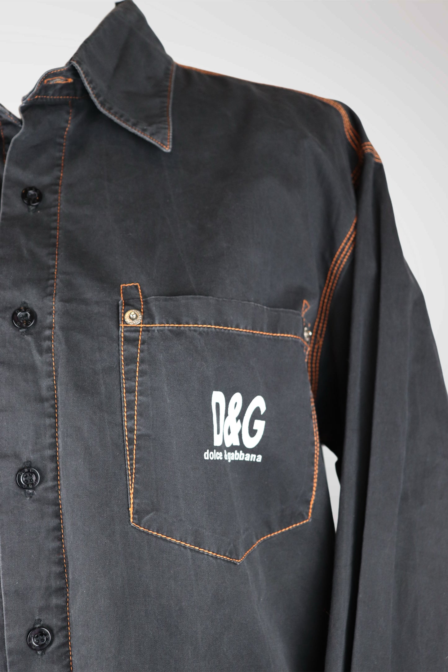 Dark denim shirt with a pocket featuring D&G logo on a white background
mint condition vintage
designer archive piece
rare runway sample
one of a kind vintage
limited edition designer
authentic vintage designer
rare vintage designer find
collectible vintage fashion
high-end vintage clothing
luxury vintage apparel
designer vintage statement piece
genuine vintage couture
archival designer clothing
runway vintage fashion
vintage designer investment piece