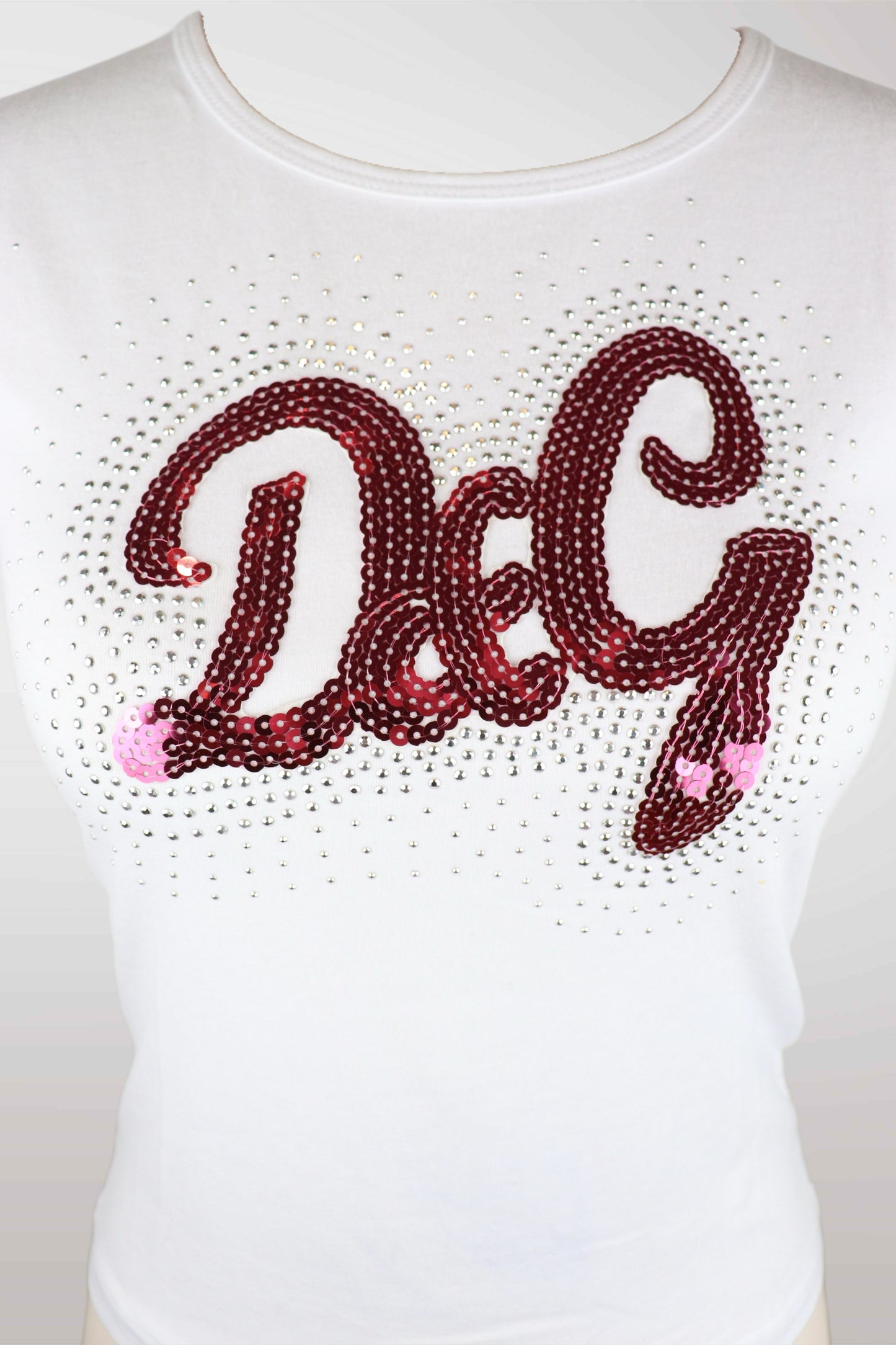White shirt with 'DG' in red rhinestone letters on a plain background
mint condition vintage
designer archive piece
rare runway sample
one of a kind vintage
limited edition designer
authentic vintage designer
rare vintage designer find
collectible vintage fashion
high-end vintage clothing
luxury vintage apparel
designer vintage statement piece
genuine vintage couture
archival designer clothing
runway vintage fashion
vintage designer investment piece