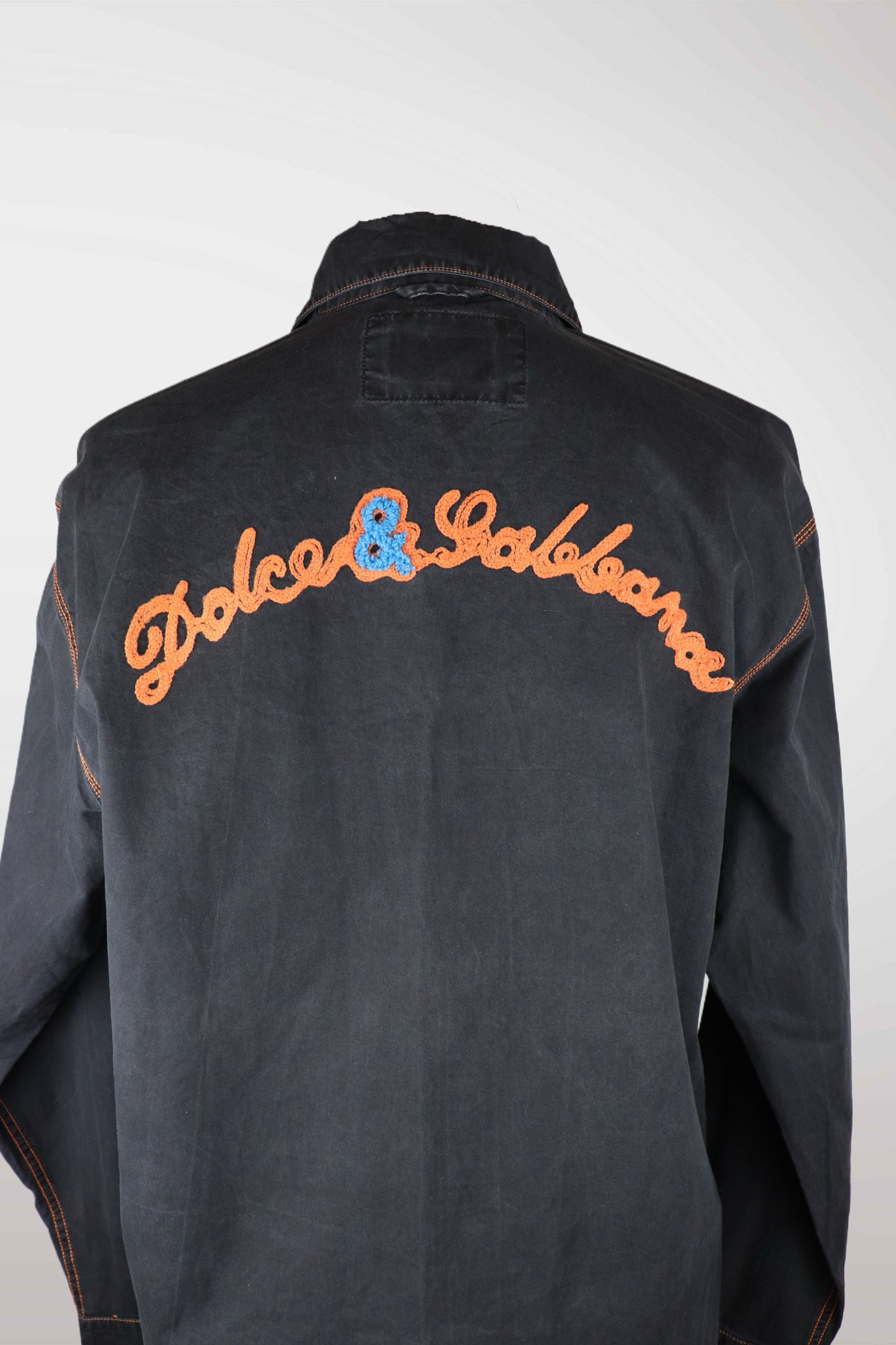 dolce & gabbana Black jacket with orange and blue text on the back against a white background
mint condition vintage
designer archive piece
rare runway sample
one of a kind vintage
limited edition designer
authentic vintage designer
rare vintage designer find
collectible vintage fashion
high-end vintage clothing
luxury vintage apparel
designer vintage statement piece
genuine vintage couture
archival designer clothing
runway vintage fashion
vintage designer investment piece