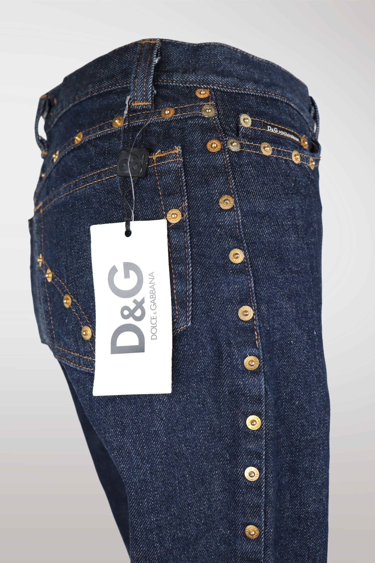 Blue jeans with gold buttons and a D&G tag on a white background
mint condition vintage
designer archive piece
rare runway sample
one of a kind vintage
limited edition designer
authentic vintage designer
rare vintage designer find
collectible vintage fashion
high-end vintage clothing
luxury vintage apparel
designer vintage statement piece
genuine vintage couture
archival designer clothing
runway vintage fashion
vintage designer investment piece