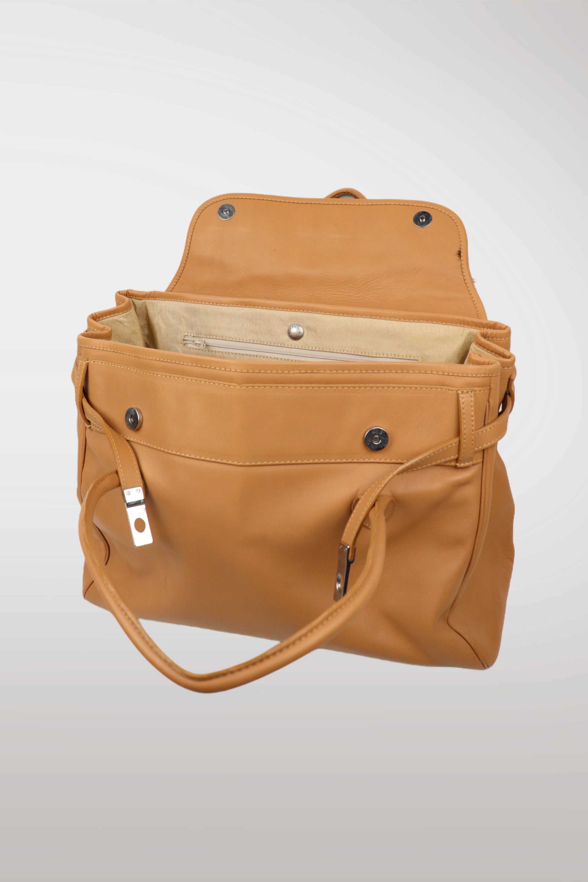 Brown leather bag with open front pocket on a light gray background