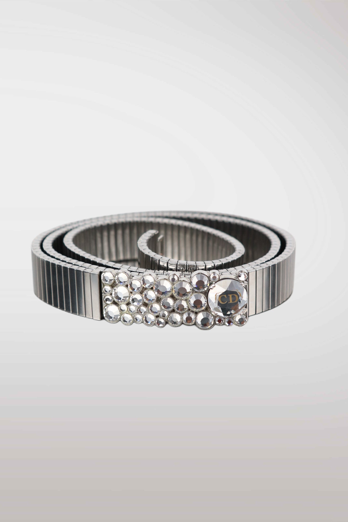 Silver belt with pearl-like embellishments on a light gray background