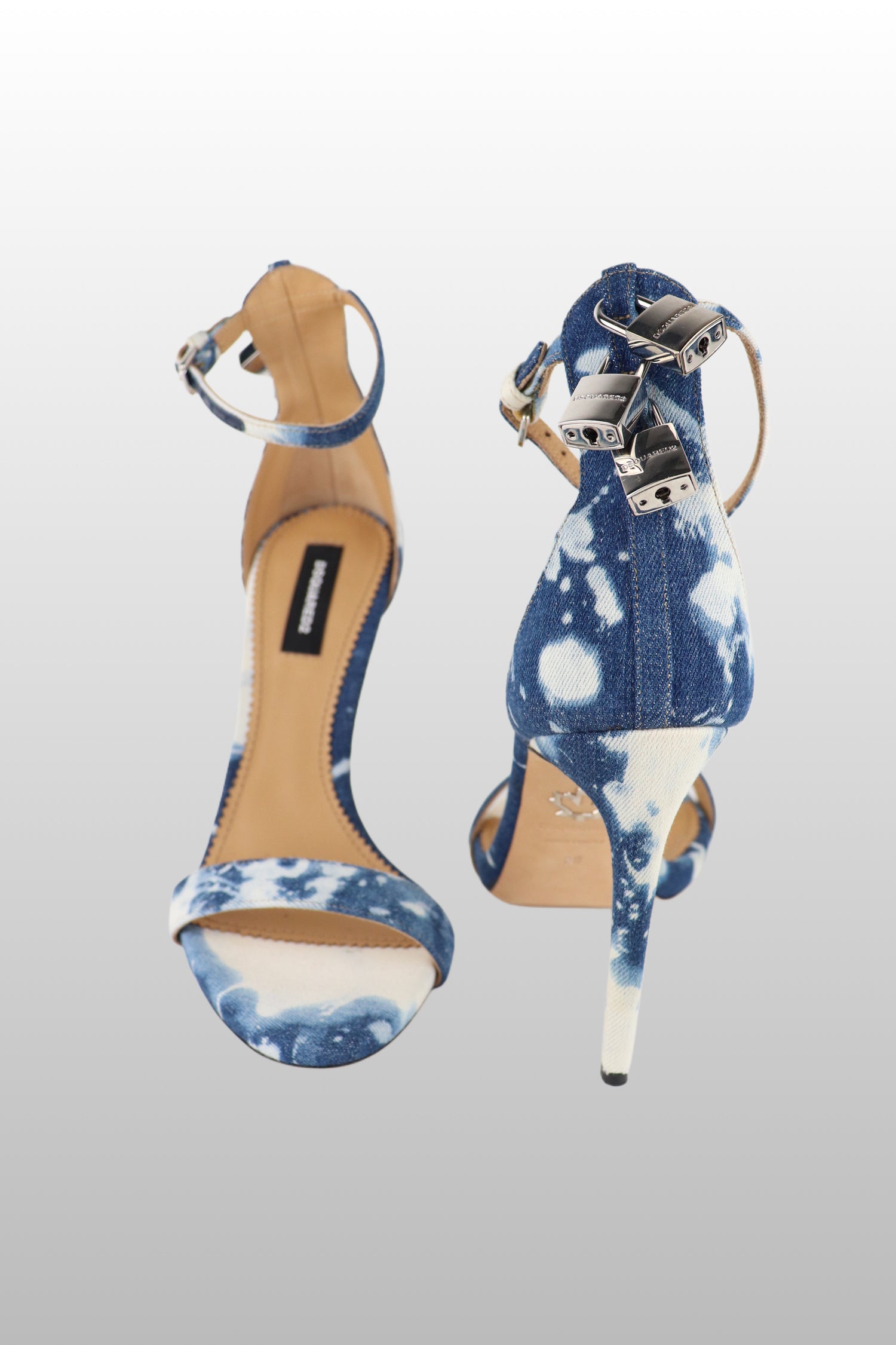 A pair of Dsquared2 stiletto heels with denim material and silver hardware, displayed against a white background.
