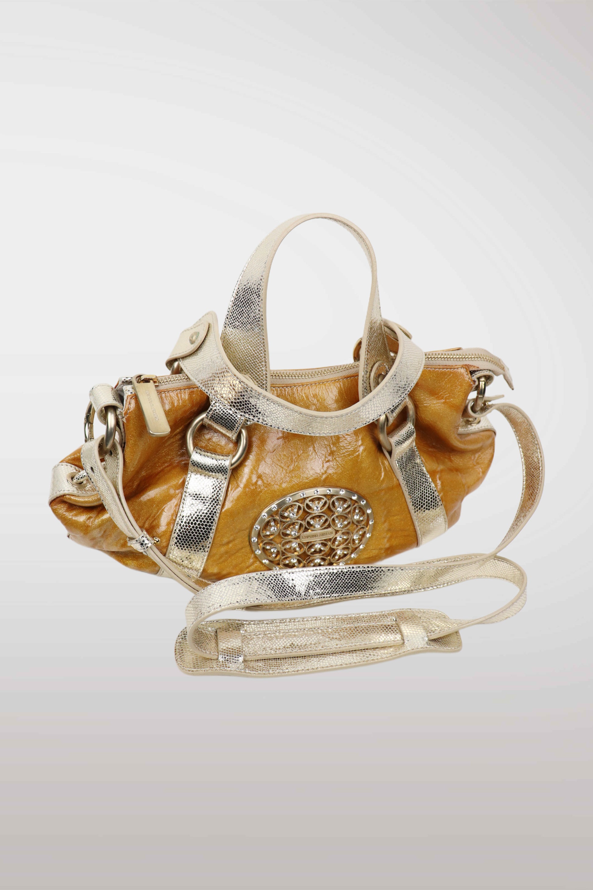 Designer handbag with gold and silver accents on a light gray background