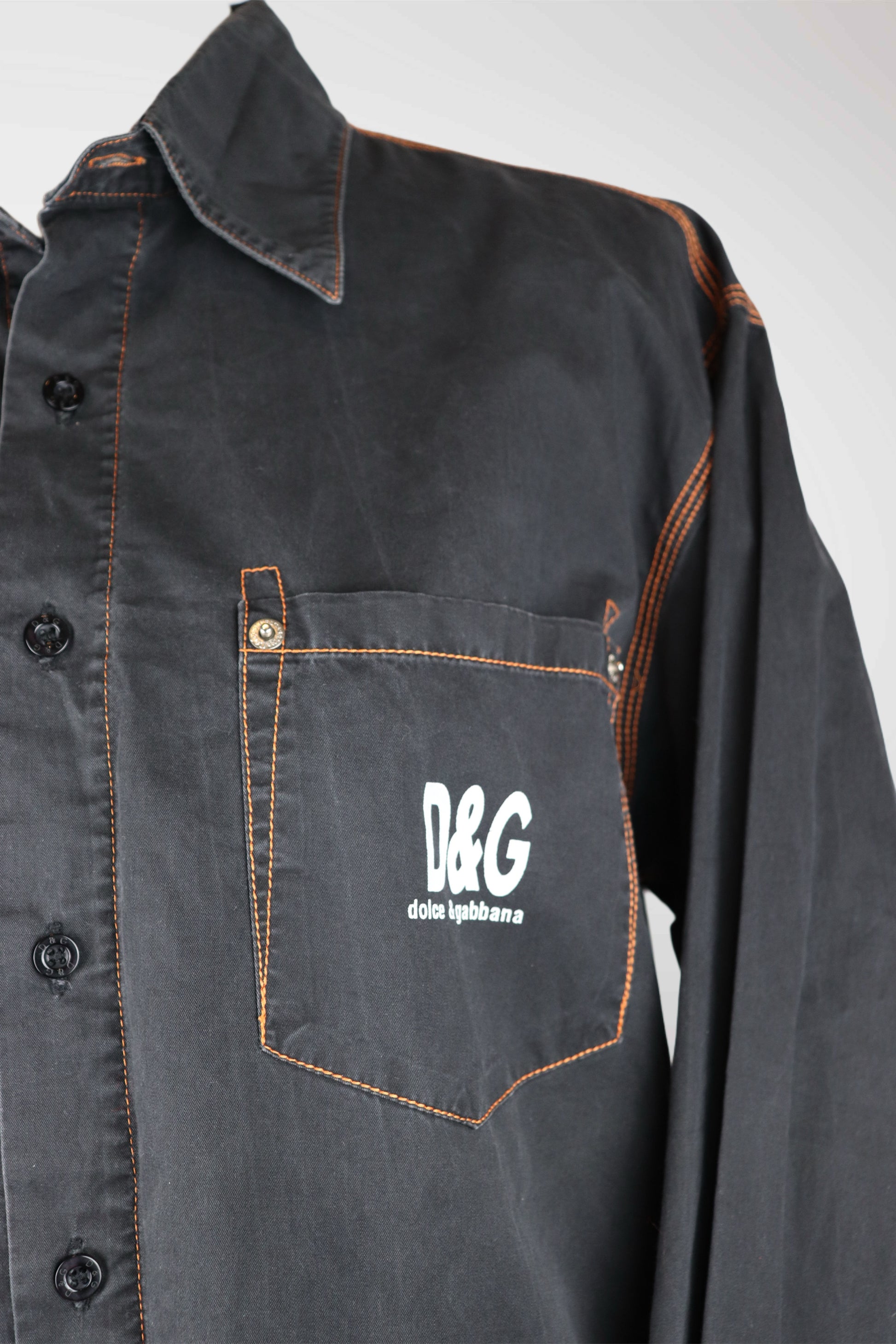 Dark denim shirt with a pocket featuring D&G logo on a white background
mint condition vintage
designer archive piece
rare runway sample
one of a kind vintage
limited edition designer
authentic vintage designer
rare vintage designer find
collectible vintage fashion
high-end vintage clothing
luxury vintage apparel
designer vintage statement piece
genuine vintage couture
archival designer clothing
runway vintage fashion
vintage designer investment piece