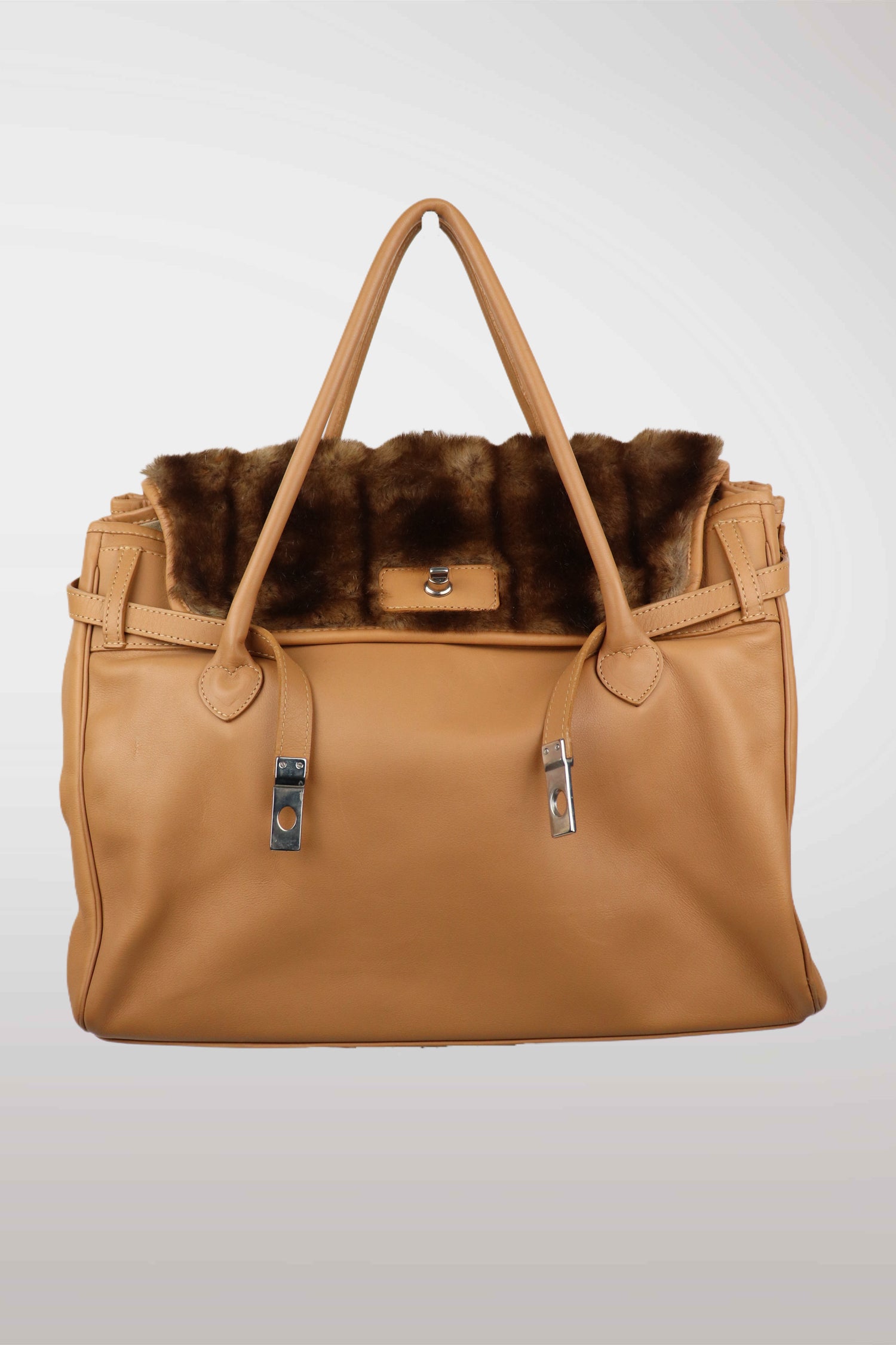 Tan handbag with fur trim on a light gray background
