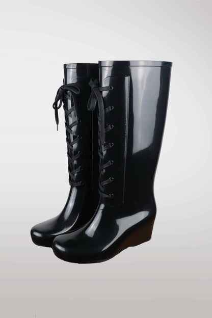 Yves Saint Laurent women’s black wedge rain boots with lace-up front design, glossy waterproof rubber finish, mid-calf height, and hidden platform heel — luxury designer rain footwear combining elegance and practicality, perfect for chic all-weather style