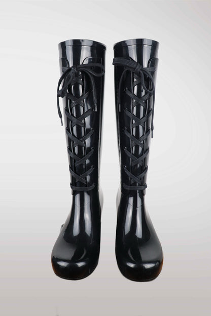 Yves Saint Laurent women’s black wedge rain boots with lace-up front design, glossy waterproof rubber finish, mid-calf height, and hidden platform heel — luxury designer rain footwear combining elegance and practicality, perfect for chic all-weather style